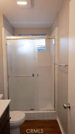 a bathroom with a granite countertop sink a toilet and a mirror