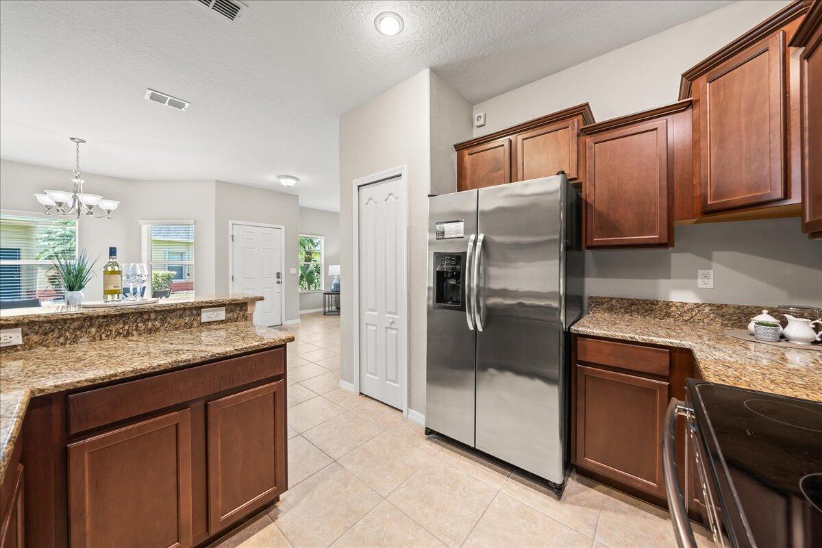 3795 Sansome Circle Melbourne, FL 32940 - Photo 11 of 76 a kitchen with granite countertop a refrigerator and a sink