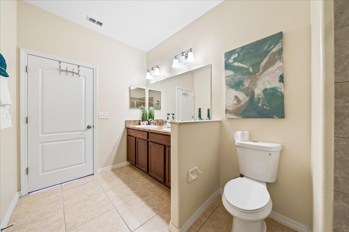 3795 Sansome Circle Melbourne, FL 32940 - Photo 16 of 76 a bathroom with a toilet sink and mirror