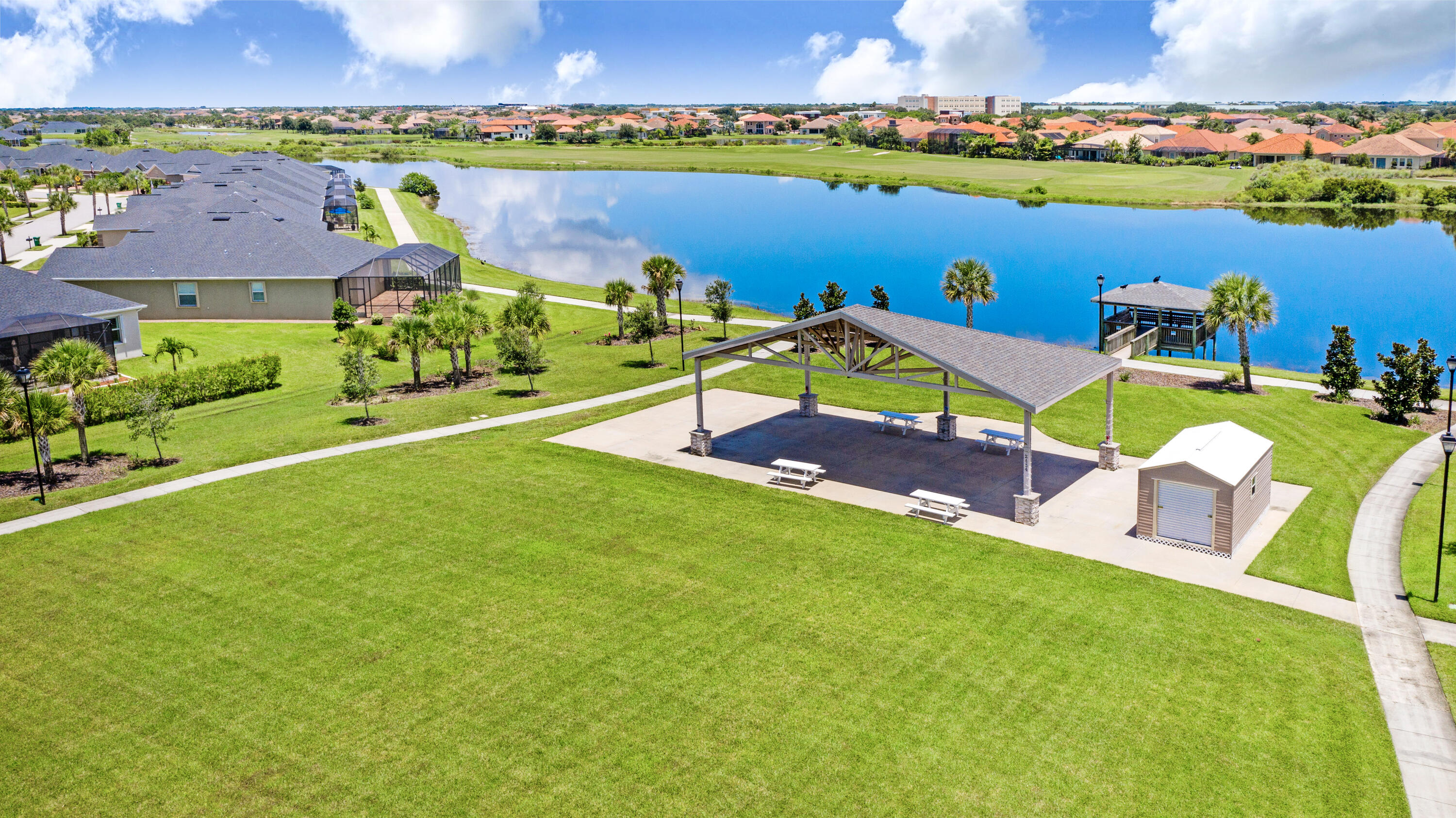 3795 Sansome Circle Melbourne, FL 32940 - Photo 69 of 76 an aerial view of a house with a garden and lake view