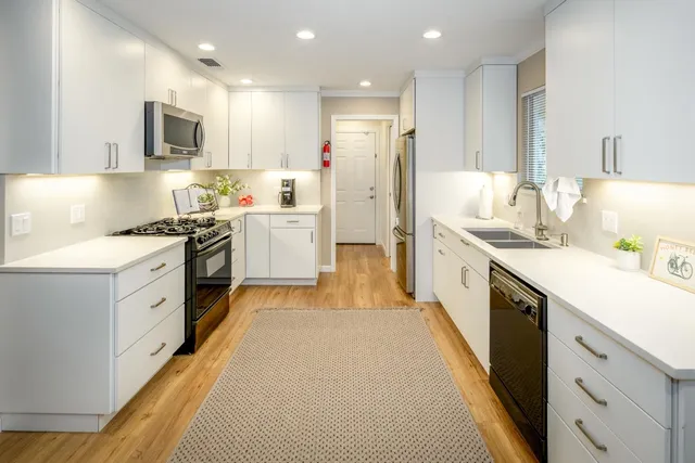 a kitchen with a sink stove and refrigerator