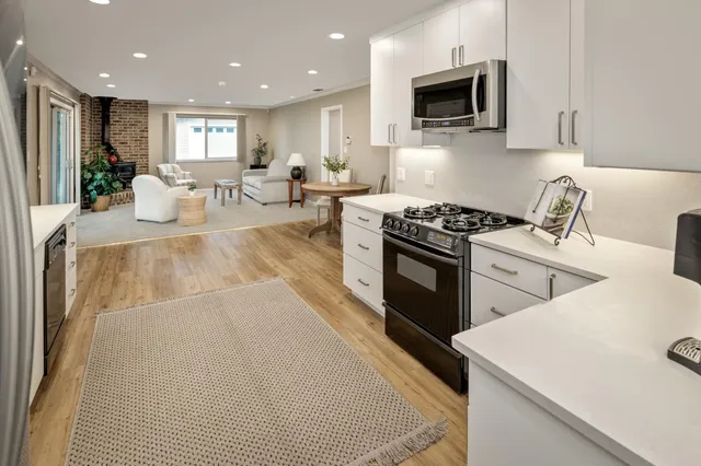 a kitchen with a stove a sink and a microwave