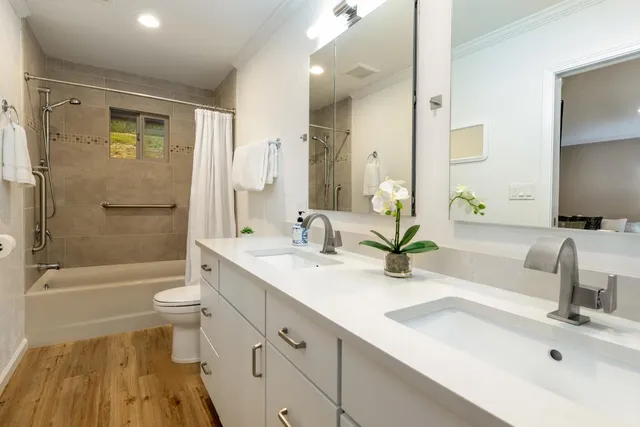a bathroom with double sink and a mirror