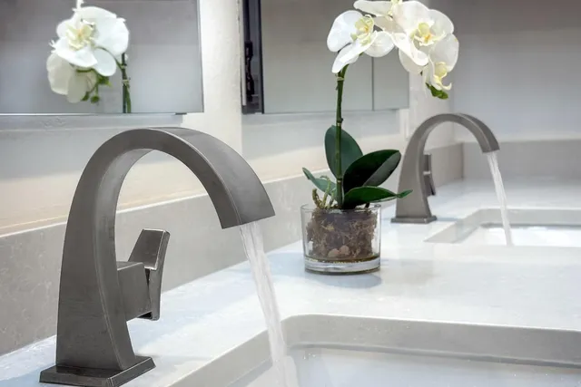 a spacious bedroom with a bed and a large window