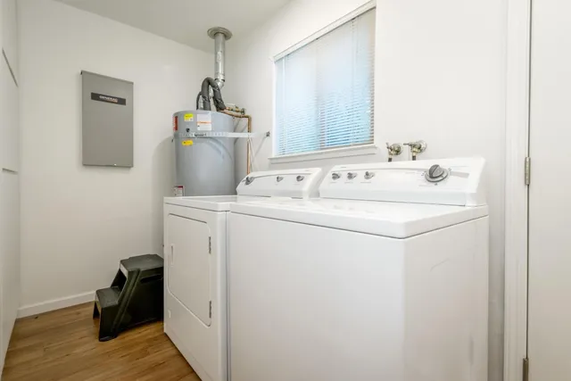 a bathroom with a sink toilet and window