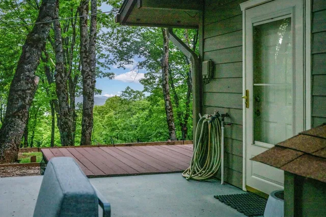 an aerial view of a house with garden space and trees