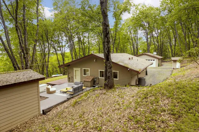 an aerial view of a house with swimming pool and porch