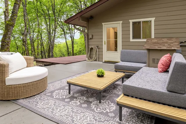 a backyard of a house with outdoor seating