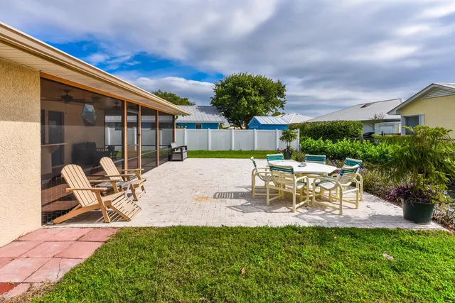 a view of a patio with a table and chairs