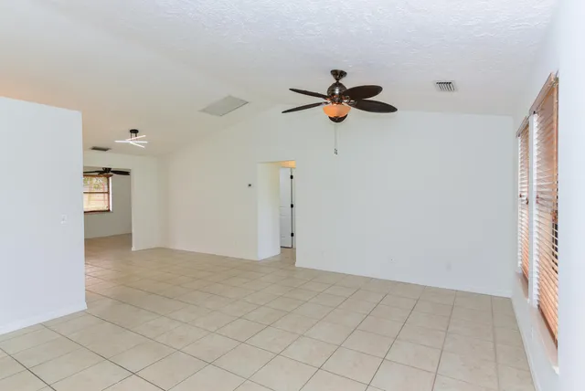 a view of a kitchen with wooden cabinet and a ceiling fan
