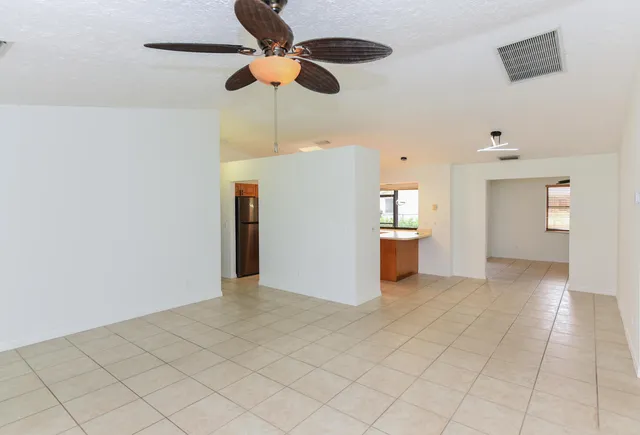 a large space with a window and a refrigerator