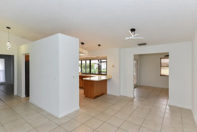 a kitchen with kitchen island sink stove and refrigerator