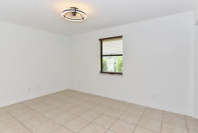 a spacious bathroom with a granite countertop sink mirror and a shower