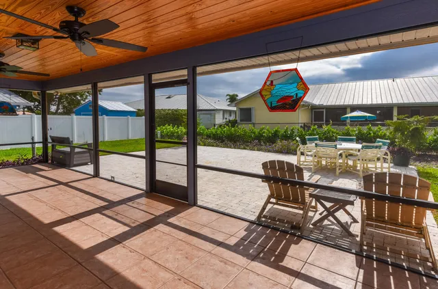 a view of a patio with a table and chairs under an umbrella