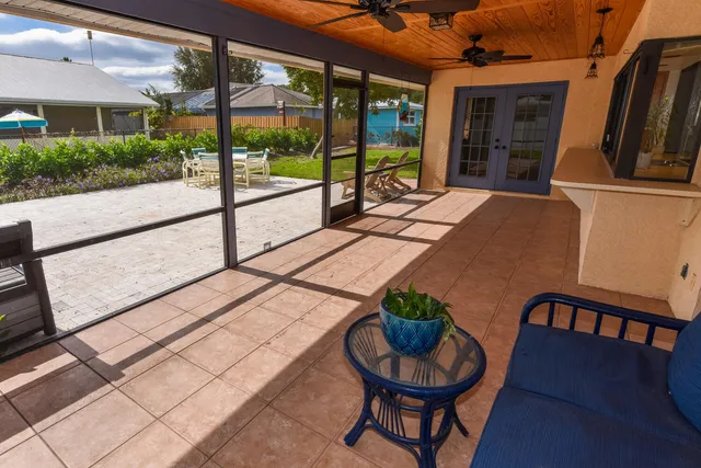 a building outdoor space with patio furniture and potted plants