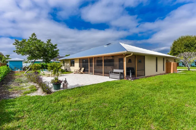 a view of a house with a yard and sitting area