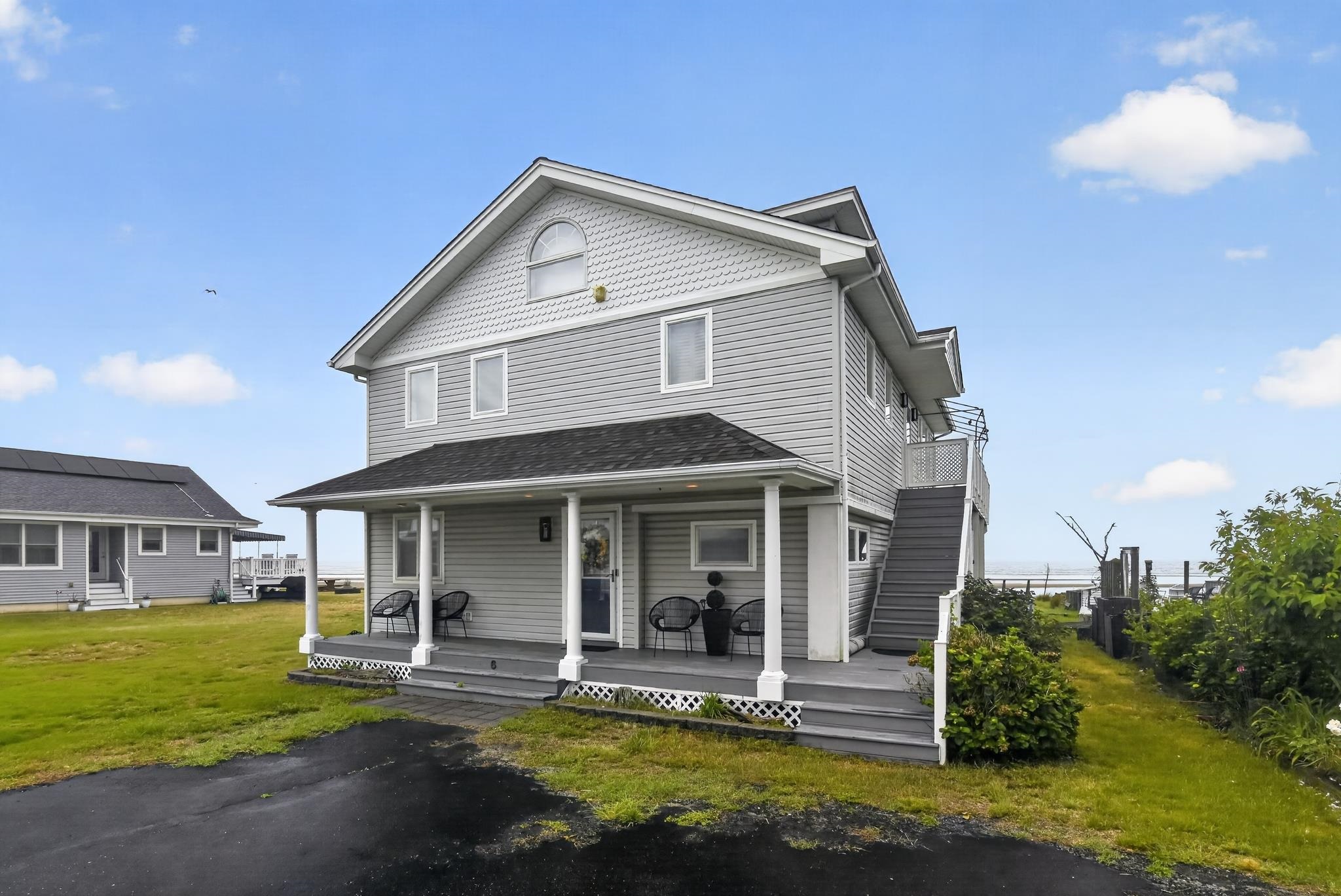6 Pierces Point Road Cape May Court House, NJ 08210 - Photo 30 of 30 a front view of a house with a yard glass top table and chairs