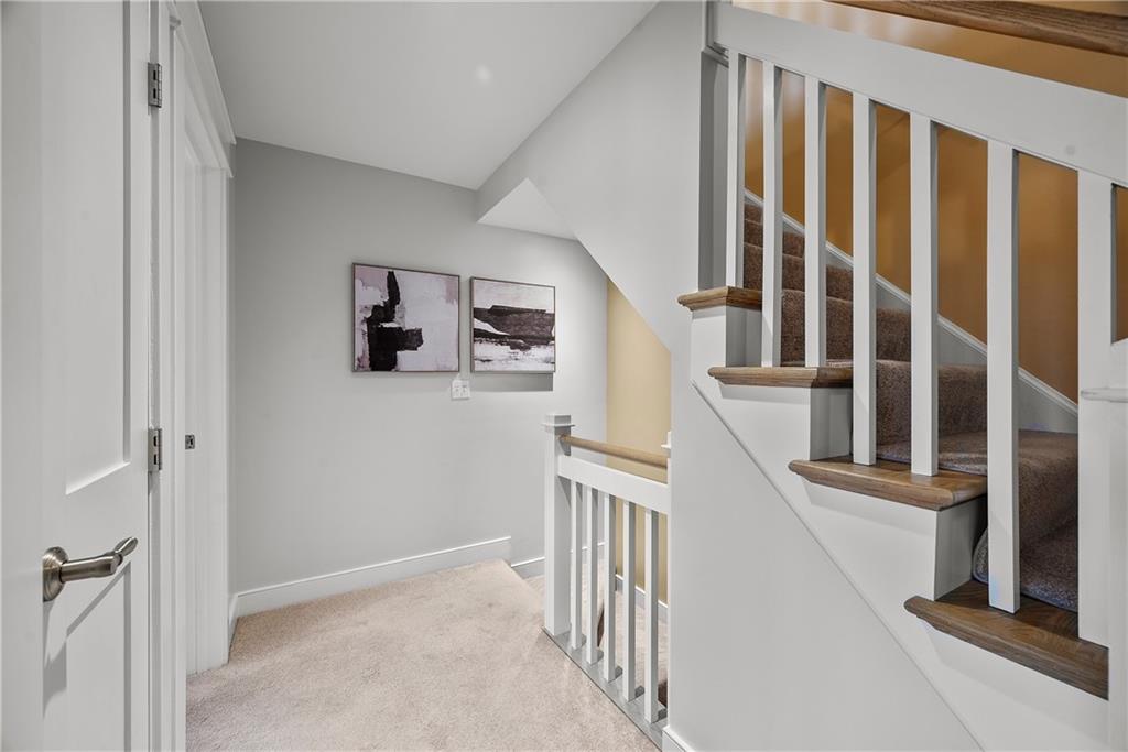 706 Ivy Street, Unit 2 Pittsburgh, PA 15232 - Photo 18 of 35 a view of staircase with lots of frames on wall and stairs