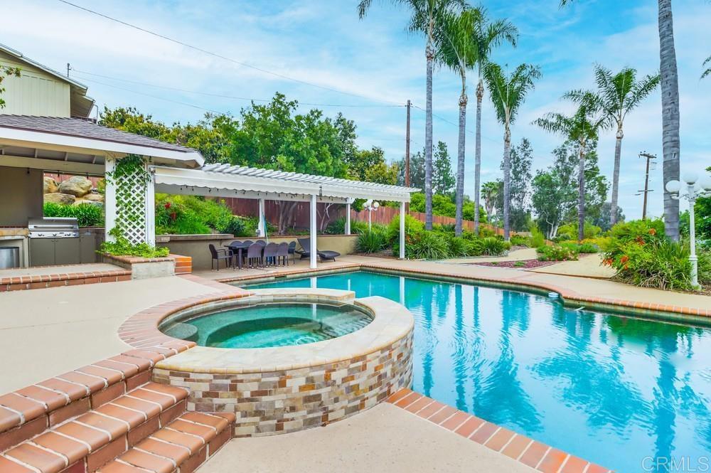 a view of swimming pool with outdoor seating and plants