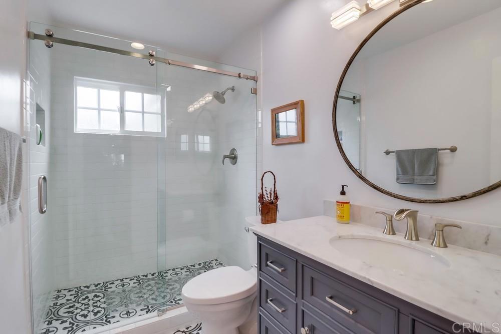 1601 Hidden Mesa Road El Cajon, CA 92019 - Photo 20 of 31 a bathroom with a sink a toilet a mirror and shower