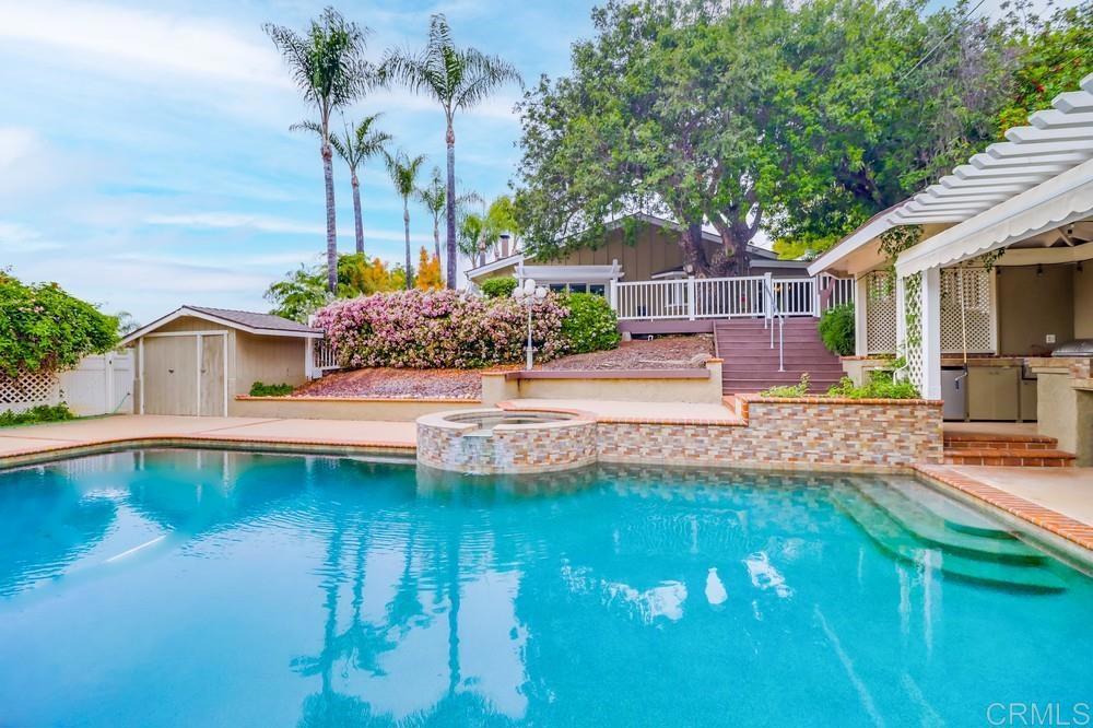 1601 Hidden Mesa Road El Cajon, CA 92019 - Photo 25 of 31 a front view of a house with swimming pool lawn chairs and outdoor seating