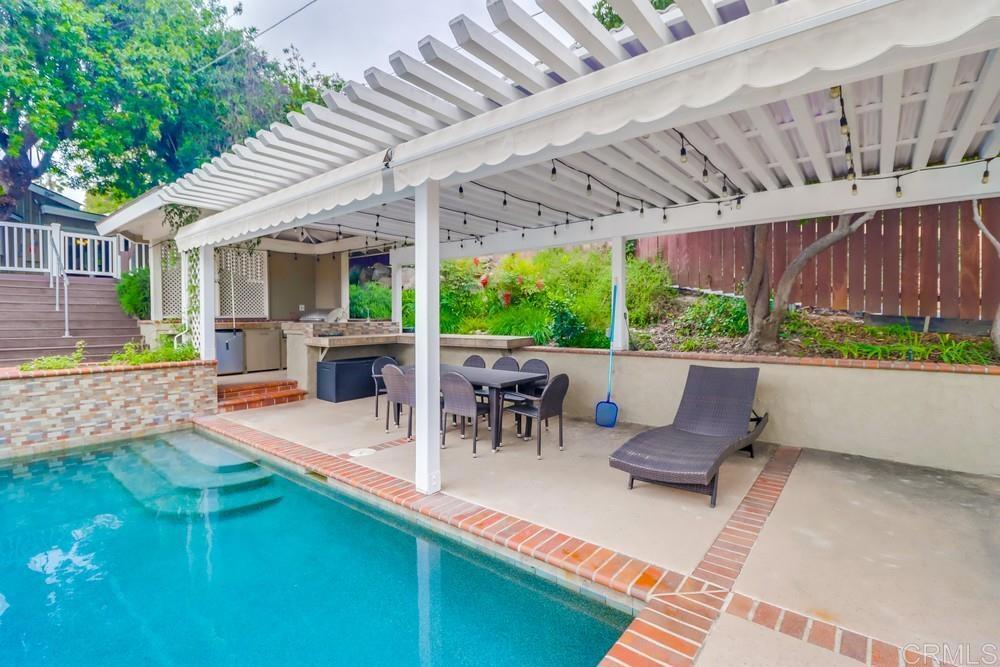 1601 Hidden Mesa Road El Cajon, CA 92019 - Photo 27 of 31 a view of a patio with table and chairs potted plants with wooden floor and fence