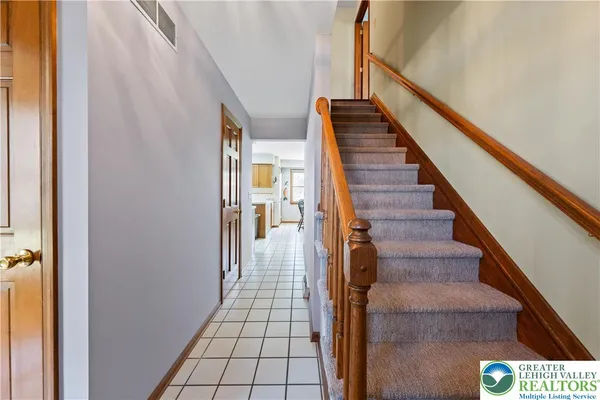 a view of entryway and hall with wooden floor