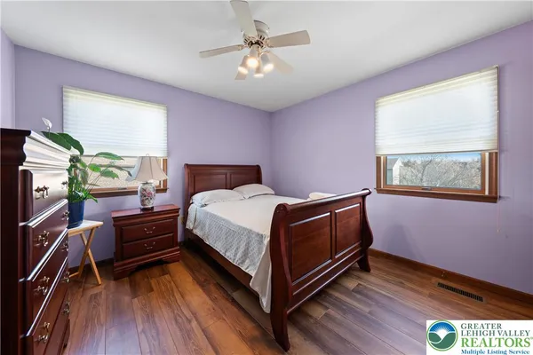 a bedroom with a bed dresser and a window