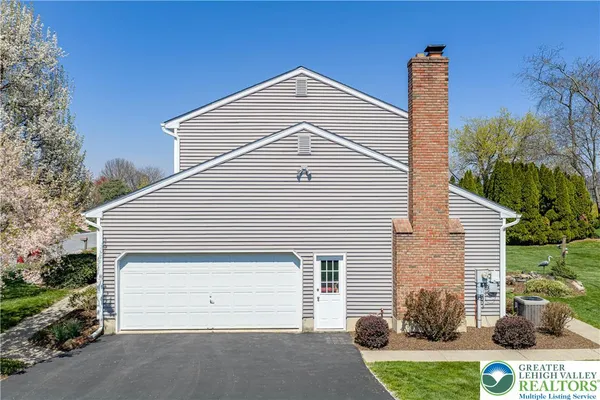 a view of a garden with plants and a bench