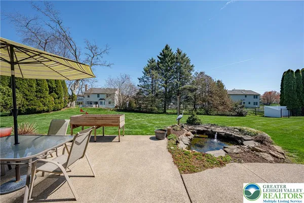 a backyard of a house with table and chairs