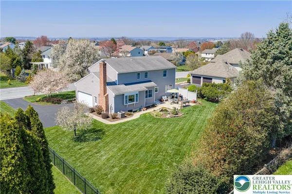 an aerial view of a house with a swimming pool