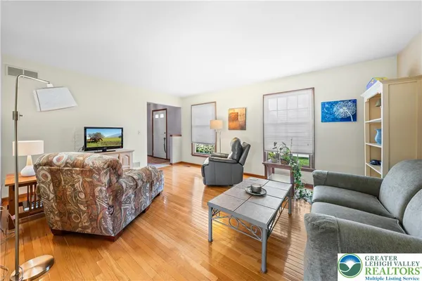 a living room with furniture and a lamp