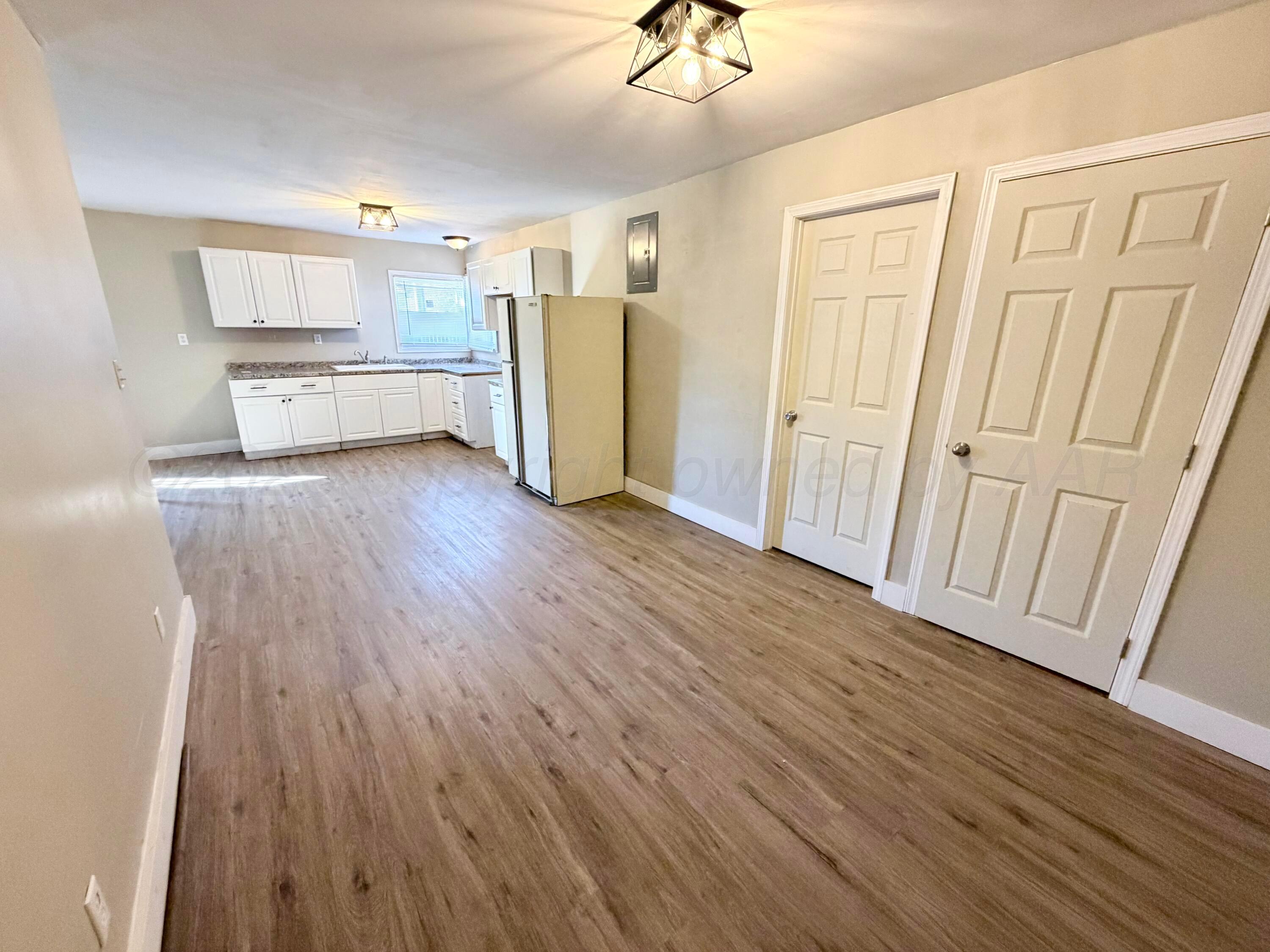 1409 El Paso Street Wellington, TX 79095 - Photo 14 of 22 a view of kitchen with furniture and wooden floor