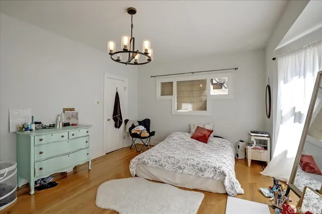 a view of a livingroom with workspace and a window