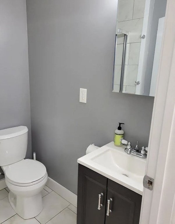 8 Marvel Street, Unit 2 Taunton, MA 02780 - Photo 11 of 17 a bathroom with a sink a toilet and a mirror