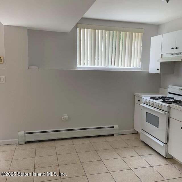 Undisclosed Address Staten Island, NY 10309 - Photo 3 of 7 a kitchen with white cabinets and a stove top oven