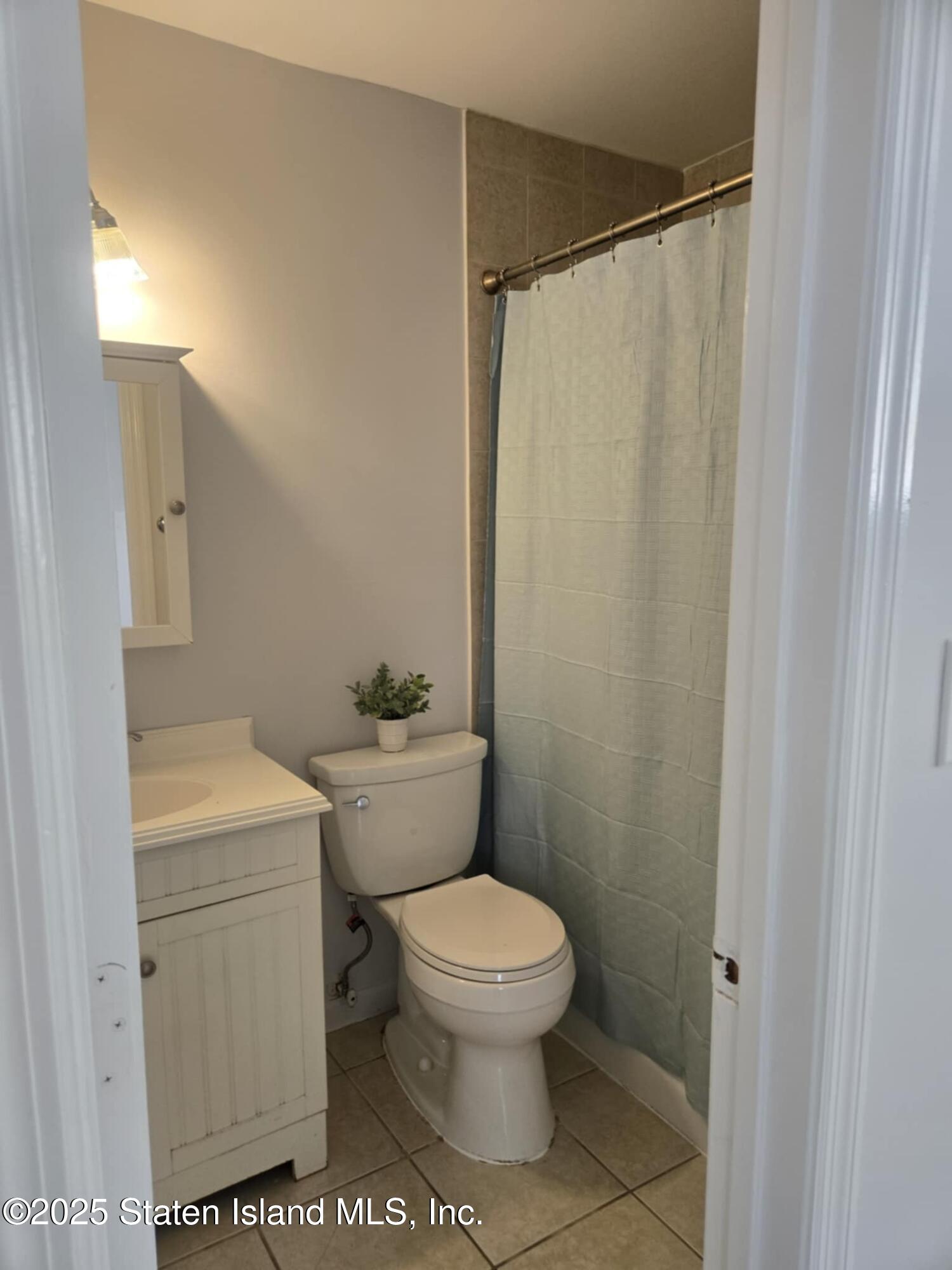 Undisclosed Address Staten Island, NY 10309 - Photo 5 of 7 a bathroom with a toilet a sink and a shower