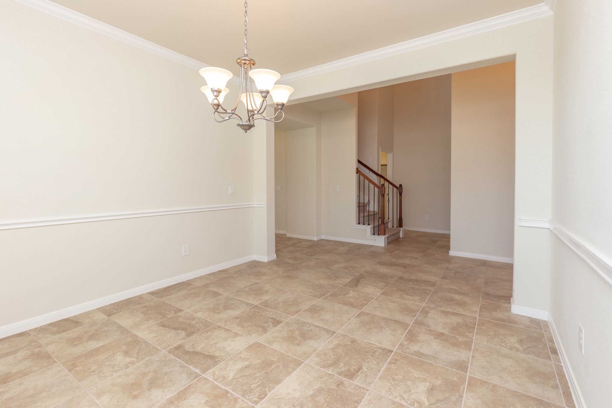 10 Log House Court Tomball, TX 77375 - Photo 12 of 50 a view of an empty room with chandelier