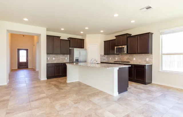 an empty room with window and a ceiling fan
