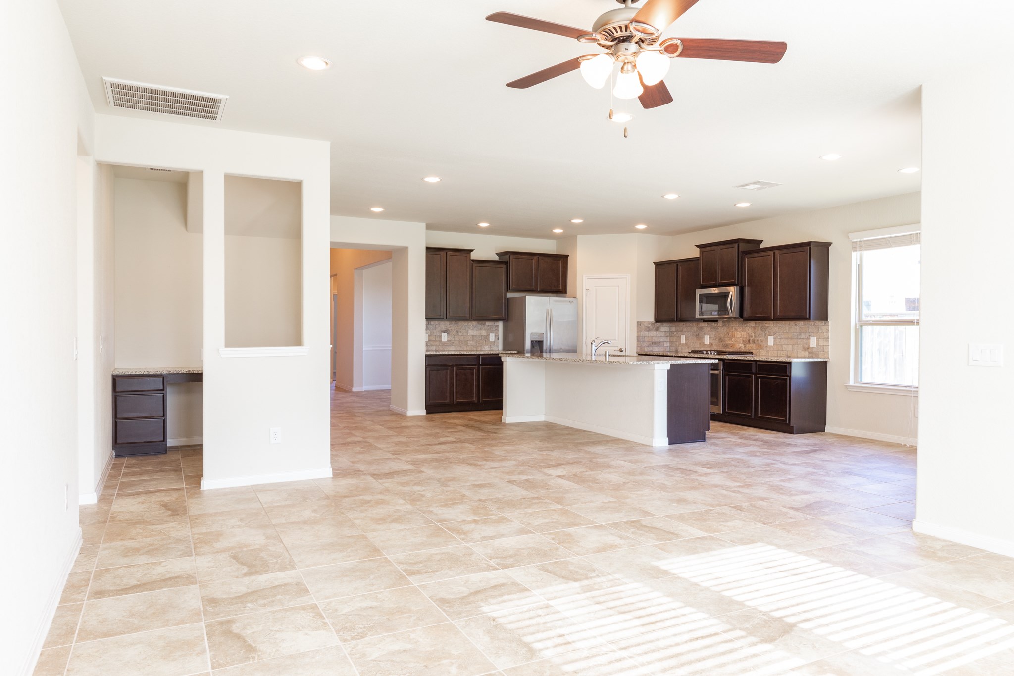 10 Log House Court Tomball, TX 77375 - Photo 24 of 50 a view of kitchen with stainless steel appliances kitchen island granite countertop refrigerator and microwave