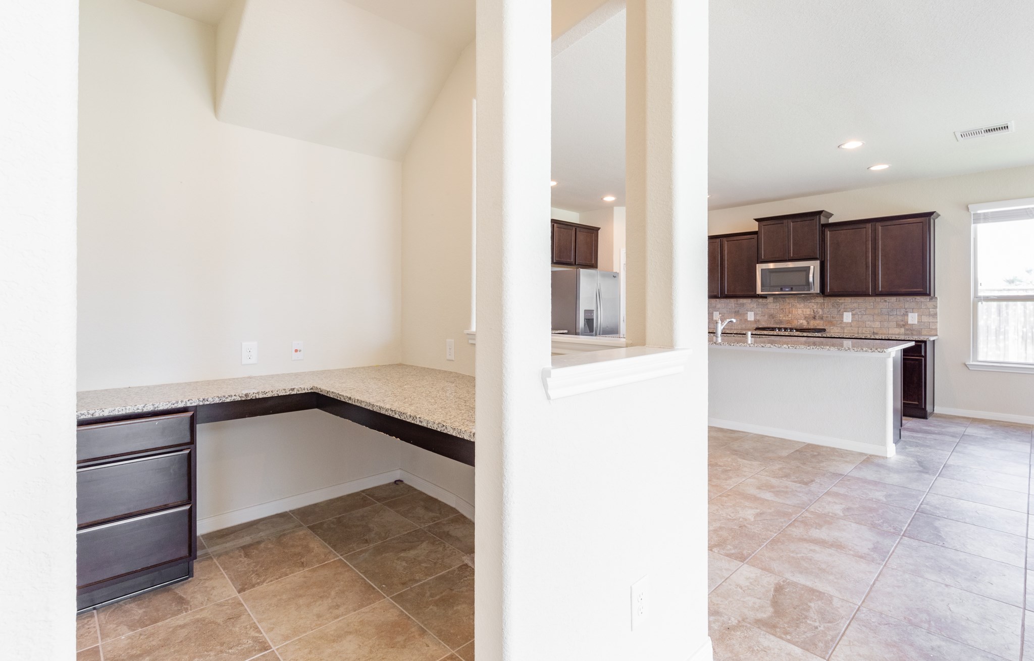 10 Log House Court Tomball, TX 77375 - Photo 29 of 50 a view of kitchen with stainless steel appliances granite countertop a refrigerator and a sink