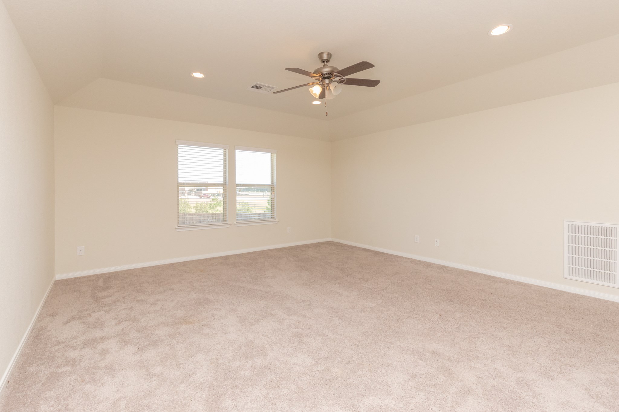 10 Log House Court Tomball, TX 77375 - Photo 43 of 50 an empty room with windows and ceiling fan view