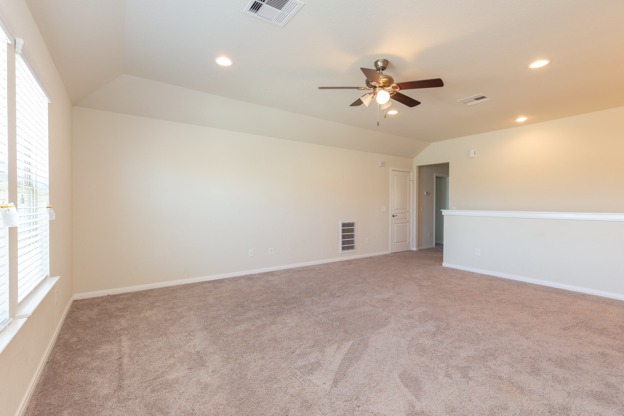 10 Log House Court Tomball, TX 77375 - Photo 46 of 50 an empty room with windows and fan