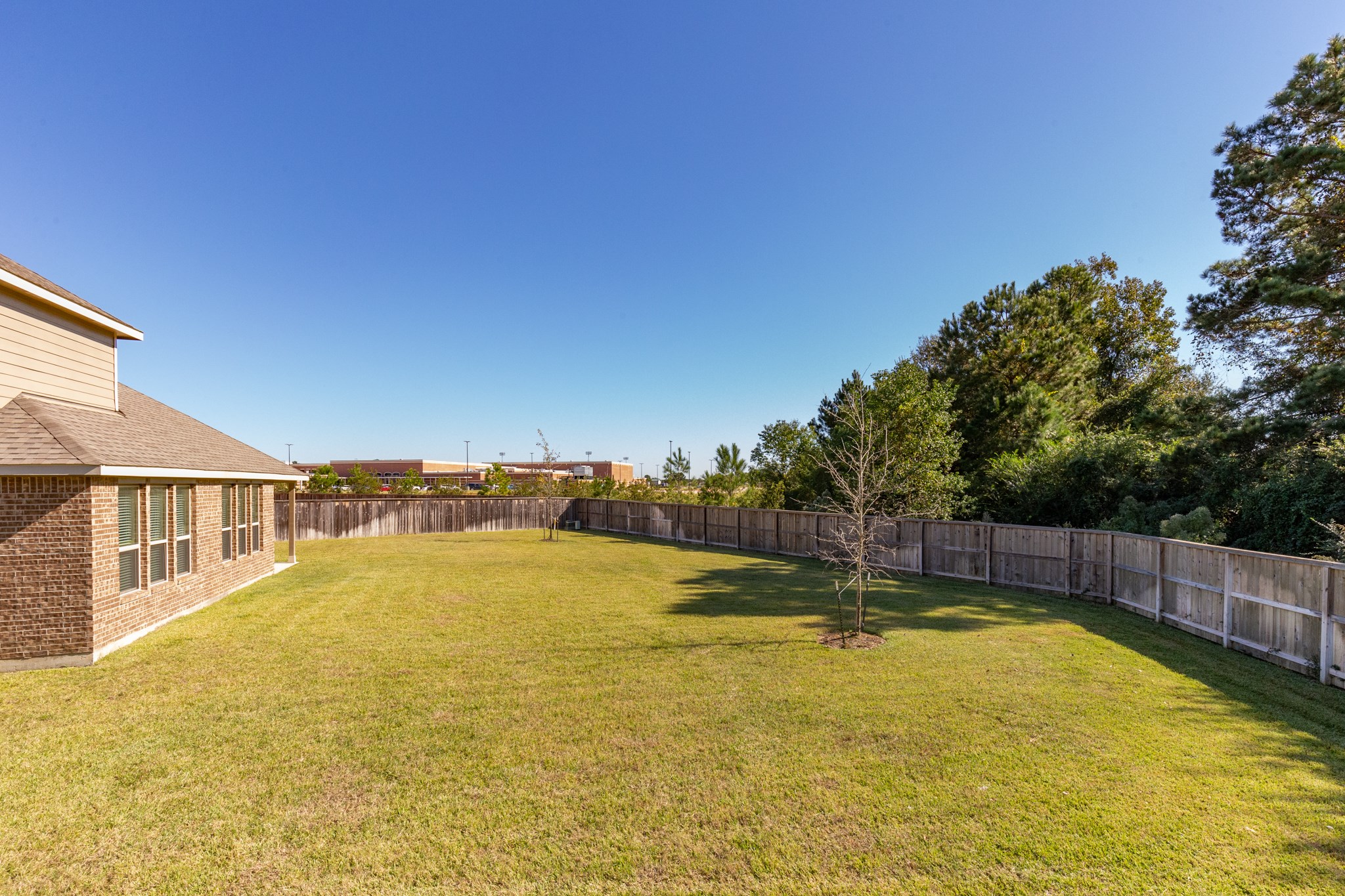 10 Log House Court Tomball, TX 77375 - Photo 47 of 50 a view of a swimming pool with an outdoor seating and yard
