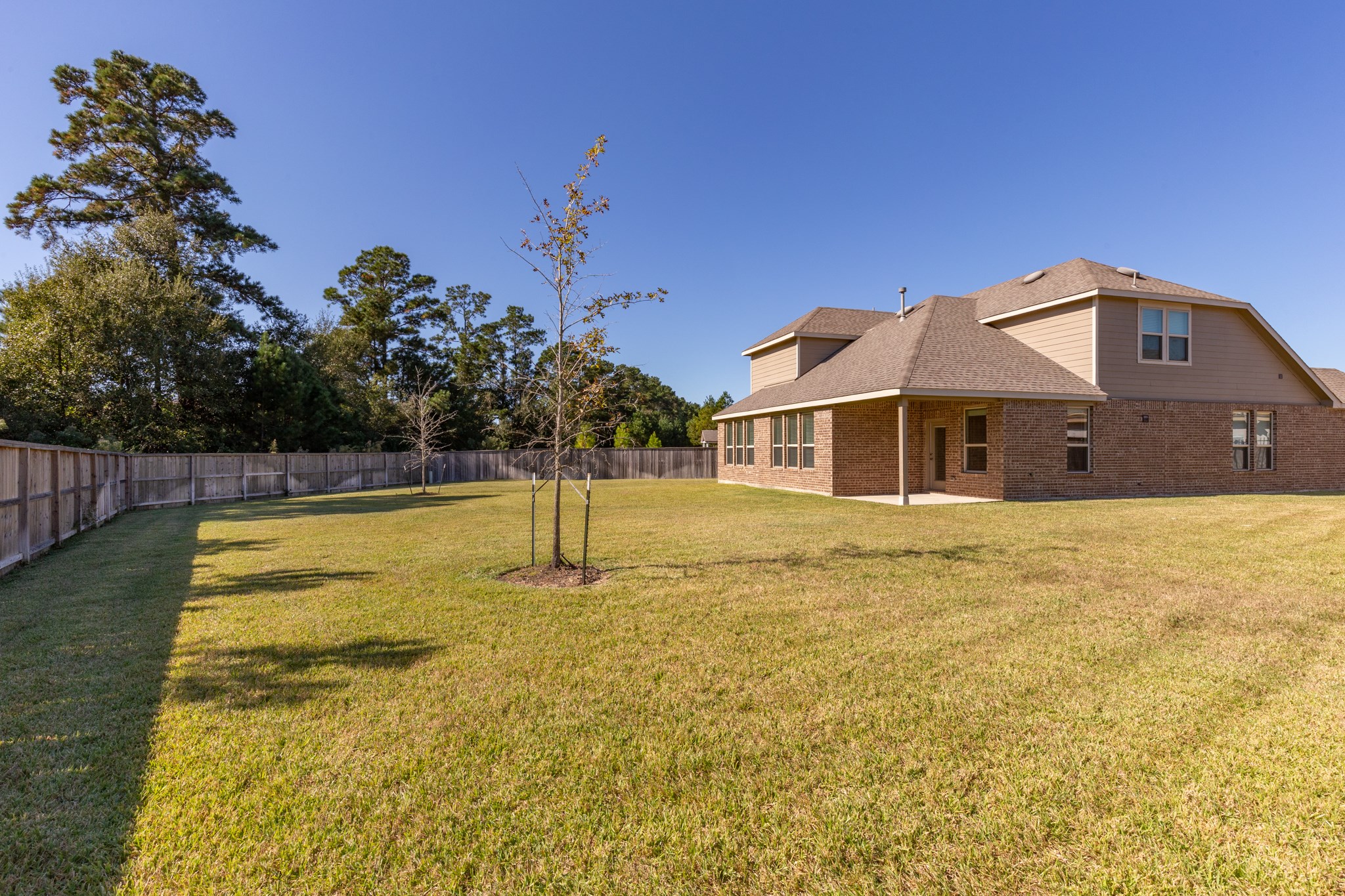 10 Log House Court Tomball, TX 77375 - Photo 48 of 50 a front view of a house with a yard