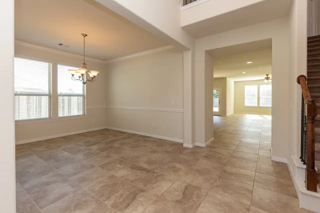 a kitchen with stainless steel appliances granite countertop a stove top oven a sink and a refrigerator