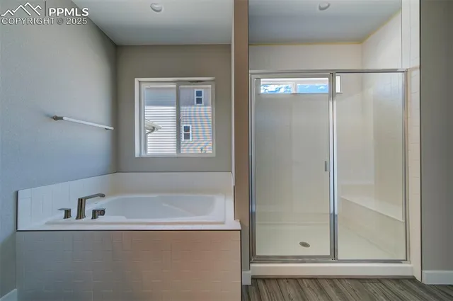 a bathroom with a tub and shower