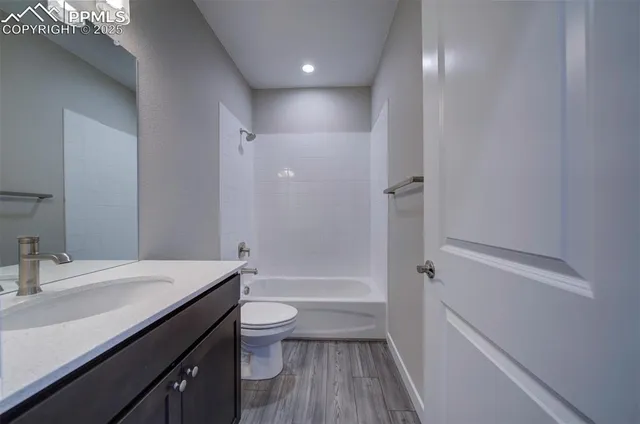 a bathroom with a sink a toilet a tub and shower