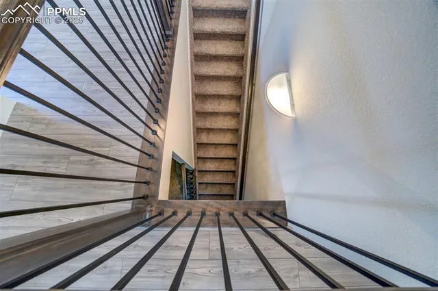 a view of a room with stairs and wooden floor