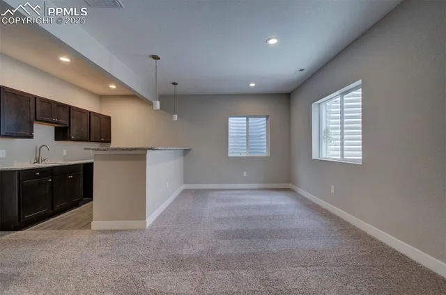 a view of a kitchen with a sink dishwasher and a fireplace